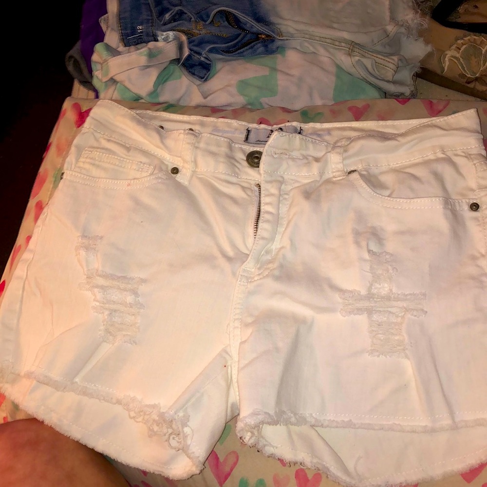 Distressed white jean shorts